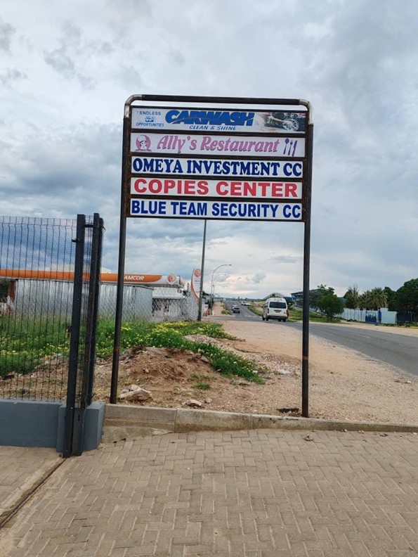 Omeya Investment listed on a shared business sign